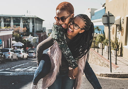 study-abroad-student-giving-her-friend-a-piggyback-ride-in-cape-town-south-africa.jpg